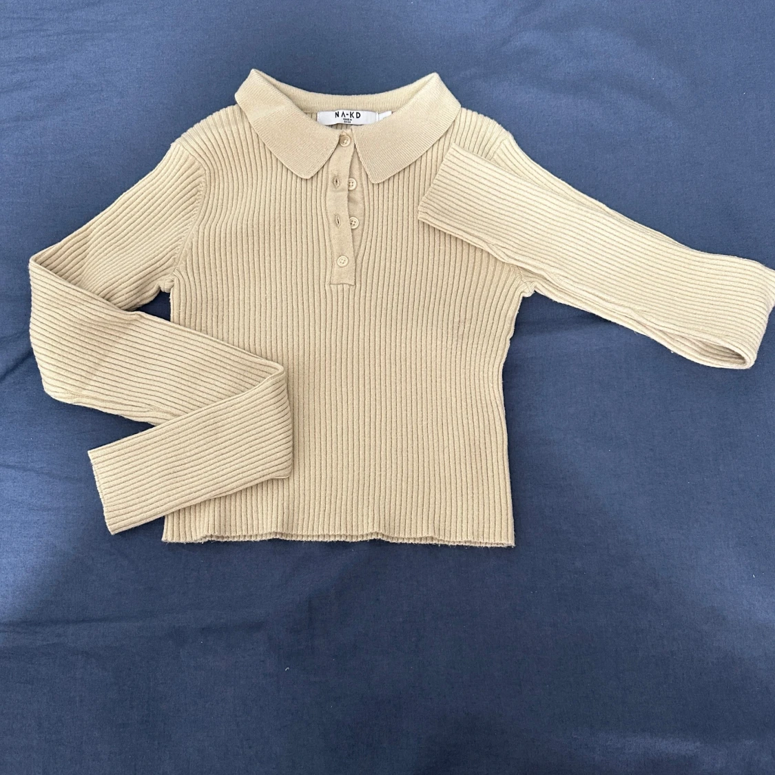 Beige ribbad polotröja från NA-KD