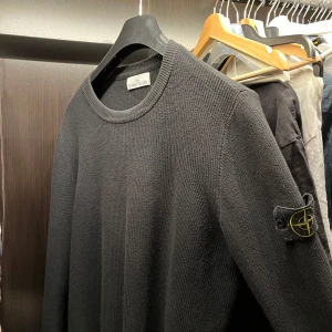 Svart tröja från Stone Island - Säljer en stickad svart tröja från Stone Island i mycket bra skick. Tröjan är långärmad och har en klassisk rund halsringning. Perfekt för både höst och vinter, och den är gjord i ett bekvämt stickat material. En snygg detalj är den ikoniska loggan på ärmen. Passar perfekt för en casual look! Storlek L, (ÄKTA) kvitto finns ej, då den är köpt för ett tag sedan ! Pris kan diskuteras vid snabb affär! 