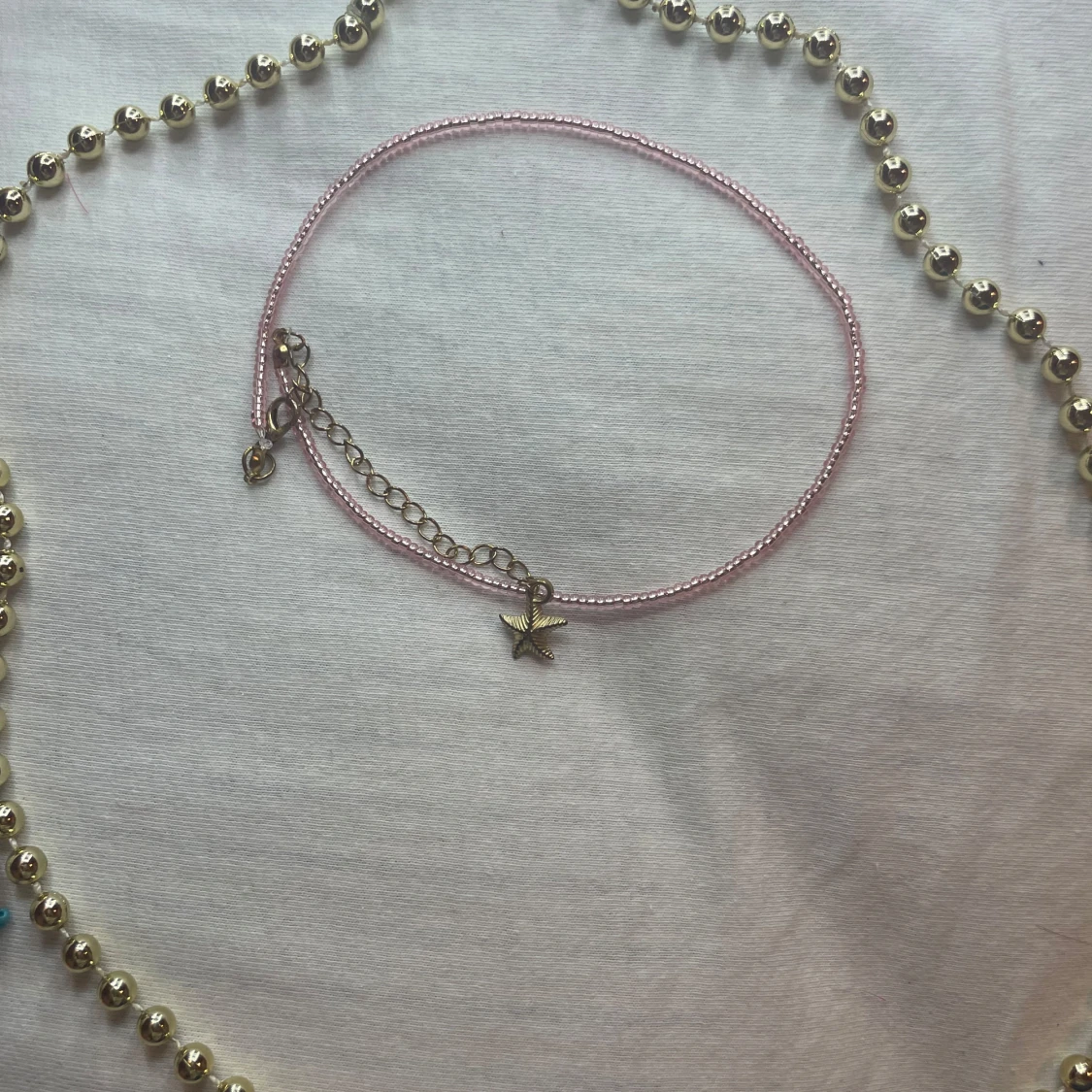 Rosa pärlhalsband med sjöstjärneberlock - 91