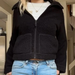Svart teddyjacka med dragkedja - ⚠️kontakta mig innan köp⚠️Mysig svart teddyjacka i normal passform med dragkedja framtill. Perfekt för kyliga höst- och vinterdagar. Jackan har långa ärmar och två stora fickor framtill. Den är både stilren och bekväm, idealisk för vardagsbruk.