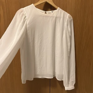 Blus - Vit blus från Vila, genomskinliga armar, i storlek 40. Men passar mindre också ifall man vill ha lite större. Aldrig kommit till användning därför jag säljer. Skriv till mig för mer information