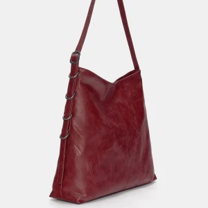 Röd axelväska i skinn - Röd väska i skinn. Väskan har justerbar axelband och ringdetaljer på sidan. Kan både ha den på axeln och cross body. Köptes för ca 1 månad sedan och knappadt använd. 