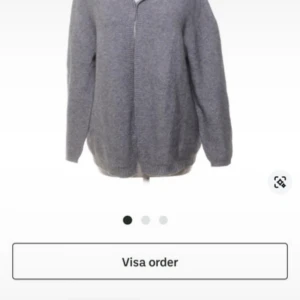 Grå kofta med dragkedja - Mysig grå kofta med dragkedja framtill. Perfekt för kyliga dagar och passar till det mesta i garderoben. Den har en enkel design med långa ärmar och en bekväm passform.