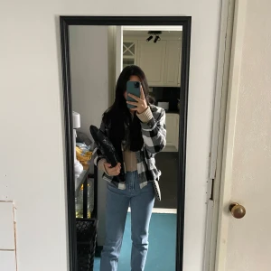 Svartvit rutig overshirt - Säljer en snygg svartvit rutig overshirt i mycket bra skick. Perfekt för höst och vår, med en skön och avslappnad passform. Den har långa ärmar och knappar framtill. Passar perfekt för en casual look eller lager på lager-stil.