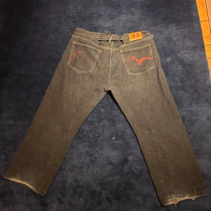 Evisu jeans  - Äkta Evisu jeans, strl 44 men passar S-M, baggy passform, har justerbart midjemått och är i 7,5/10 skick med lite hellbite. Har du nån fråga stäm gärna av, mvh Max. 