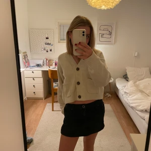 Svart kortkjol från Guess - Säljer en snygg svart kortkjol från Guess i mycket bra skick. Kjolen har en klassisk design med knapp och dragkedja fram. Perfekt för både vardag och fest! Ganska lös i midjan och lite längre än *kort