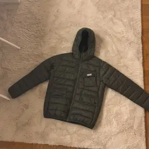 Säljer en snygg grön quiltad jacka från Barbour i storlek XL(barn storlek) Jackan har en praktisk huva och dragkedja framtill. Perfekt för höst och vinter med sitt varma fiberdun-material. Den är i mycket bra skick och redo för nya äventyr! 🍂