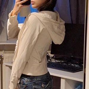 Vit hoodie med dragkedja - Säljer en snygg vit hoodie i storlek XS. Älskar den så mycket men säljer den då jag inte kan ha den. Passar alla outfits och är super skön!