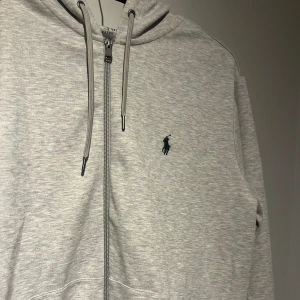 Polo Ralph Lauren zip - Säljer denna riktigt populära zip hoddien från polo Ralph Lauren. I ny skick. Den är i storlek medium men passar även S. Den är i ljus grå färg och bra kvalitet. Original pris 2195 kr från zalando mitt pris 1500. Vid snabb affär kan priset diskuteras