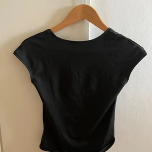 Öppen rygg t shirt - Vet ej vilket märke eller storlek men skulle gissa på S/M. Jag har aldirg använt den då jag inte trivdes i att ha öppen rygg. Skicket är på topp.