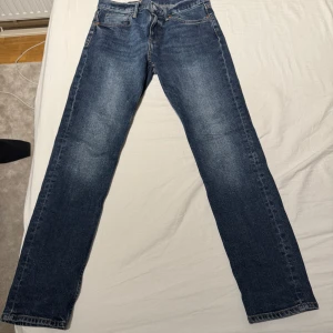 Blå jeansbyxor - Klassiska blå jeansbyxor med en straight passform. De har en dragkedja och knappar framtill. Perfekta för en avslappnad stil. W:30 längd 32 pris kan diskuteras 