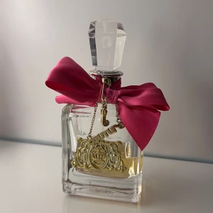 Juicy couture parfym viva la juicy - Säljer min Juicy couture parfym. Med doft av vilda bär och mandarin, kaprifol, gardenia och jasmin. Ambra, katsuraträd, vanilj, sandelträ och bränd mandel. Allt samlat i en tuff glasflaska med gyllene Juicy-berlock och en vacker fuchsiaröd rosett. Själva flaskan är en 100 ml och det är ungefär 50 ml kvar. 