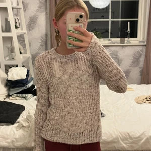 Stickad tröja  - Detta är en stickad vit, rosa och lila tröja som är jätte mysig och skön. Älsker den nu när det är kallt ute! Har använt den 1 gång för den är stor för mig. 