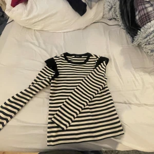 Randig långärmad tröja från ONLY - Säljer en snygg randig tröja från ONLY i storlek M. Den är svart och vit med långa ärmar och en klassisk rund hals. Perfekt för både vardag och lite mer avslappnade tillfällen. Superbekväm och lätt att matcha med jeans eller kjol!