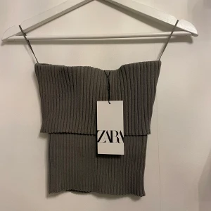 Grön Zara topp - Säljer denna fina ribstickade zara toppen i en fin grön färg. Aldrig använd och prislapp kvar på. Storlek M men passar också S