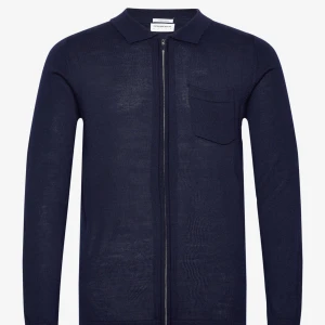 Merinoull kofta med dragkedja - Snygg mörkblå kofta i merinoull med dragkedja och bröstficka. Helt ny oanvänd med lappen kvar, endast testad en gång. Säljer då den var för liten för min kille. Har även egna bilder så skriv för fler 🫶🏼