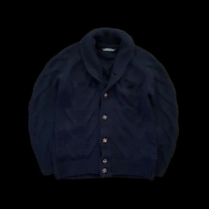 Mörkblå stickad cardigan  - Mörkblå/navyblå stickad cardigan med feta bruna detaljerade knappar och ett snyggt mönster, den är i storlek S och i mycket fint skick. Perfekt för våren och sommarkvällar. Fråga gärna om vad som helst! Priset är heller inte hugget i sten!            Mvh Distinguished Gentlemens Club!🎩                                                        