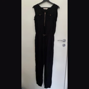 Jumpsuit kortärmad - • Normal Passform • Upplevs som storlek 34 • Använd men ej sliten • Alla bilder visar färgen bra (svart) • Mjukt, tunt tyg