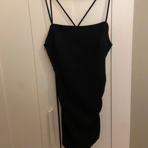 Svart klänning - Snygg svart klänning med smala axelband och en elegant passform. Perfekt för en kväll ute eller en speciell tillställning. Klänningen är helt ny med prislapp💕