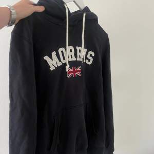 Säljer denna riktigt populära Morris hoodie i bra skick. Den är sparsamt använd. Den är mörkblå och har de populära märket på framsidan. Hoodie har även metal detaljer på snörena där det står morrris på. Vid fler frågor är det bara att höra av sig. 