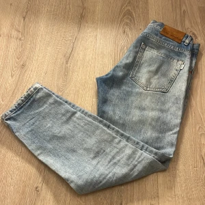 Ljusblå jeans från Woodbird - Snygga ljusblå jeans från Woodbird i modellen Doc Stein. De har en klassisk femficksdesign och en bekväm passform. Perfekta för en avslappnad stil. Stilen kallas Doc. 9/10 