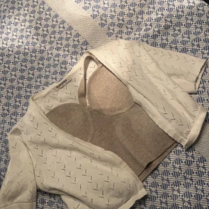 Vit bolerotopp  - Säljer en söt vit bolerotopp. Toppen har ett diskret hålmönster och korta ärmar, . Den sitter tajt och snyggt . Köptes för 250. Säljer för 60kr