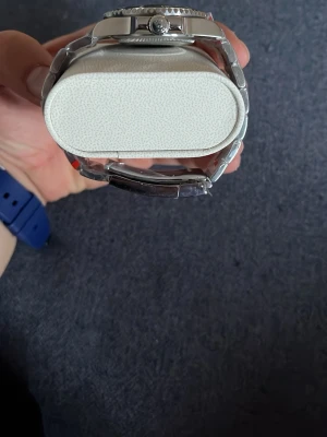 Klassisk silverfärgad klocka - Stilren klocka i silverfärgat metallarmband och svart urtavla med tydliga siffror och markeringar. Klockan har en rund form och sportig design som passar till många olika stilar.