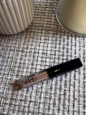 NARS flytande concealer ljus nyans - Flytande concealer från NARS i en ljus beige nyans.  Var tyvärr fel färg för mig, endast swatchat den på handen. Det är den mindre varianten. Färgen creme brulee 