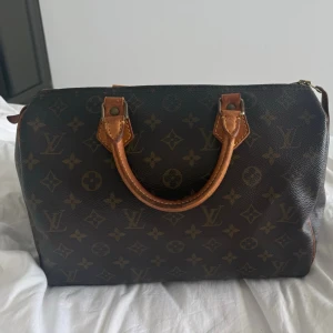 Louis Vuitton Speedy - Superfin Louis Vuitton Speedy 35 (äkta) i utmärkt skick. Canvasen är jätte fin, inga repor eller sprickor. Lädret har charmigt slitage och är naturligt patina. Dragkedjan något slitet. Insidan är jätte fräsch, ren och hel💗skriv om mer bilder önskas eller andra frågor❣️