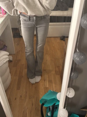 Grå bootcut jeans med broderad ficka - Säljer ett par grå bootcut jeans med snygg broderad detalj på bakfickan. Jeansen har klassisk femficksmodell och är tillverkade i mjukt denimtyg med lite stretch. Perfekta för dig som gillar en avslappnad men ändå trendig look. jag tänker att startbud är 500 sen får man buda neråt 💐💐