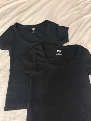 Svarta basic-T-shirts från Lager 157💕 - Två svarta bas-tshirts med rundad halsringning och korta ärmar. Perfekta till alla outfits och tillverkade i mjukt material som känns skönt mot huden. Passformen är normal och de är enkla att matcha med allt. Tröjorna är i storlek XS💕