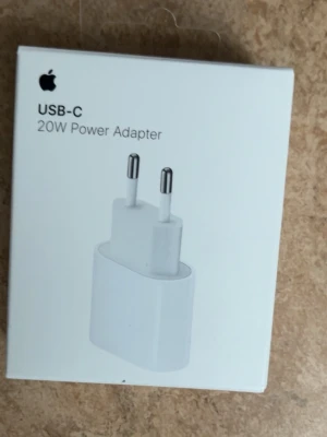 Apple USB-C 20W strömadapter - Säljer en vit USB-C 20W strömadapter från Apple. Perfekt för att ladda din iPhone eller iPad snabbt och smidigt. Kompakt design med två metallstift för vägguttag. Passar alla enheter med USB-C laddningskabel.