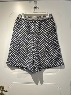 Snygga shorts | Rodebjer | stl M | Nyskick - Modellen har en elegant vidare silhuett och ger nästan en känsla av en kjol när de bärs. Väldigt snygga med enkel topp/skjorta och sandaler, sneakers eller klackar.  Midjeomkrets ca 77 cm, Längd ca 57 cm (elastisk midja) Marinblå/offwhite 