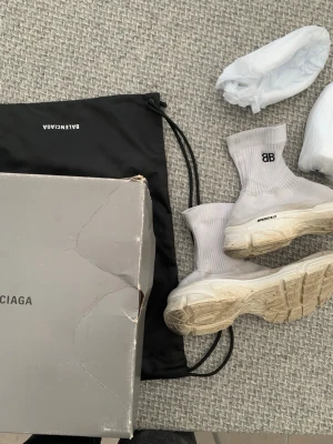 Vita Balenciaga Speed Trainer sneakers - Säljer ett par vita Balenciaga Speed Trainer sneakers med stickad ovandel och tjock sula. Skorna har BB-logga på sidan och klassisk strumpliknande design. Kommer med originalkartong och dustbag.