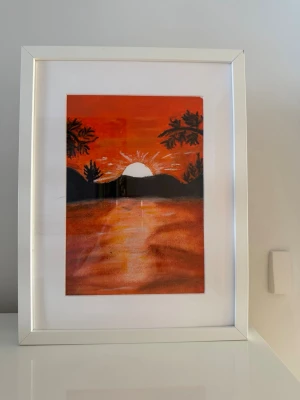 Tavla med solnedgång i vit ram - Säljer en vacker handgjord landskapsmålning med ett stämningsfullt höstmotiv och en vacker solnedgång i orange och mörka nyanser. Tavlan passar perfekt för att skapa en varm, mysig och ombonad känsla i hemmet. Målad för hand med högkvalitativ oil pastel Varma och harmoniska höstfärger Inramad i en stilren ram fran IKEA Mätt: 30 × 40 cm Unikt handgjort konstverk Passar fint i vardagsrum, sovrum eller hall. Säljes på grund av flytt.
