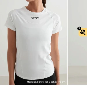 Vit t-shirt från Aim'n - Säljer en snygg och enkel vit t-shirt från Aim'n. Den är kortärmad och har en liten logga på bröstet. Perfekt för träning eller en avslappnad dag. Materialet känns mjukt och skönt mot huden! Använd men ordentligt tvättad 