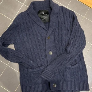 Mörkblå stickad kofta - Tja, säljer nu denna snygga mörkblå kabelstickad cardigan igfrån märket Victor. Grymt skick utan några defekter. Skriv vid minsta lilla fundering! Priset är ej hugget i stenen.