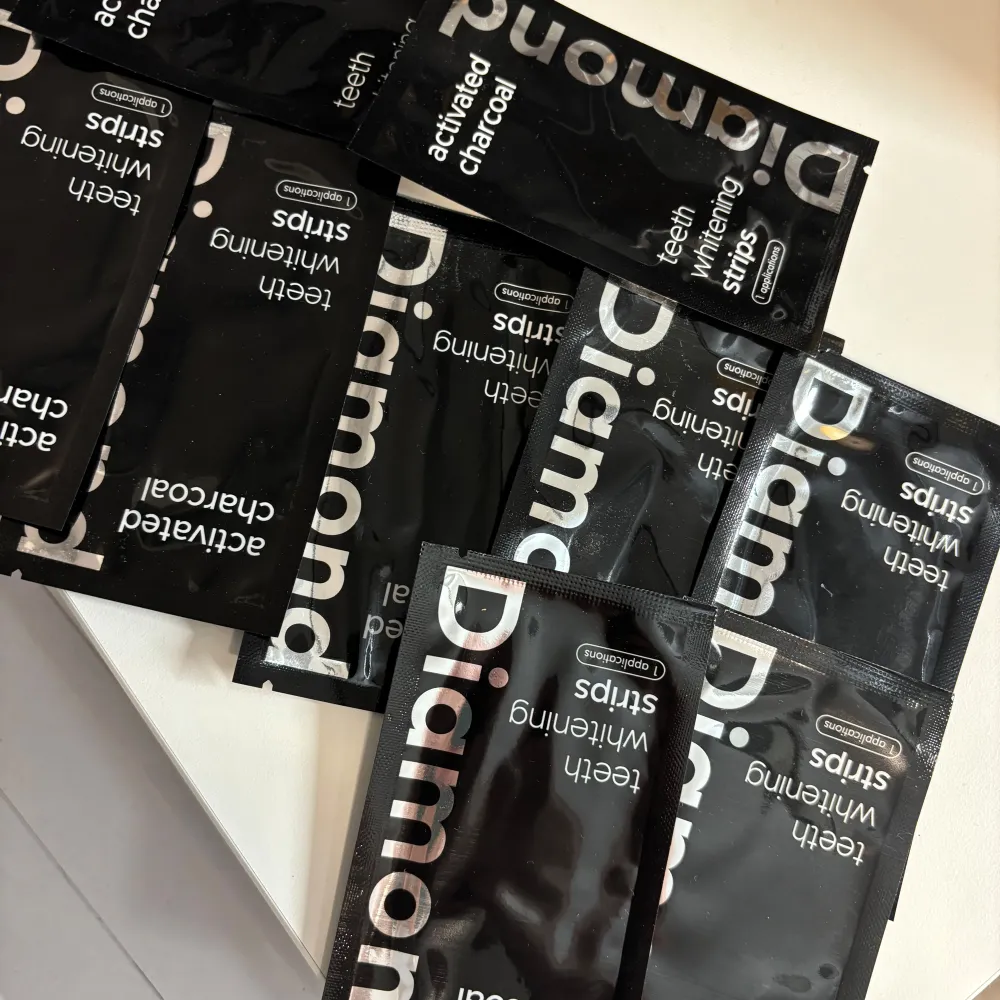 Säljer flera förpackningar av Diamond Activated Charcoal Teeth Whitening Strips. Dessa strips är designade för att ge dig ett vitare leende med hjälp av aktivt kol. Perfekt för att fräscha upp tänderna och få bort missfärgningar. Ger snabbt resultat!. Skönhet.