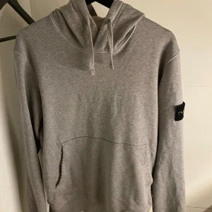 Stone island hoodie  - Tjabba, säljer denna äkta Stone island tröjan, tröjan är fläckfri förutom att den har lite rosa i luvan då den blev tvättad men en rosa tröja, se defekt på sista bilden.
