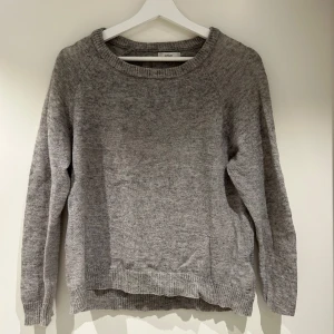 Grå stickad tröja  - Mysig grå stickad tröja från envll med rund halsringning och långa ärmar. Perfekt för kyliga dagar. Storlek S, aldrig använd.