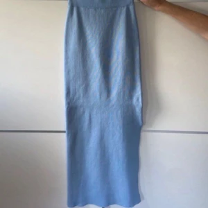 Ljusblå långkjol - En kjol från Giorgia i nyskick. Den är 90 cm lång och i ett stretchigt material vilket gör att den passar strl xs-s. Finns även en topp som tillhör kjolen, se annat inlägg (kan erbjuda bättre pris vid köp av hela sättet)