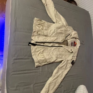 Beige jacka från para jumpers - Säljer en beige jacka från para jumpers med dragkedja och flera fickor.  Perfekt för vår och höst. Passar dig som gillar en normal passform.