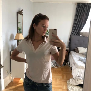 Piké Tommy Hilfiger  - Okej skick, ljusrosa piké från Tommy Hilfiger  i storlek S. 