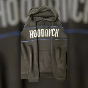 Svart hoodie från Hoodrich - Pris kan diskuteras vid snabb affär!!…Snygg svart hoodie från Hoodrich med vit text och blå detaljer. Den har en klassisk känguruficka och justerbar luva. Perfekt för en avslappnad stil men också ”uk” stil. Allt äkta, köpt för 1200kr