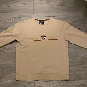 Polo club  - Snygg beige polo club tröja. Säljer på grund av att den var för liten när ja köpte den och tappade kvitto.