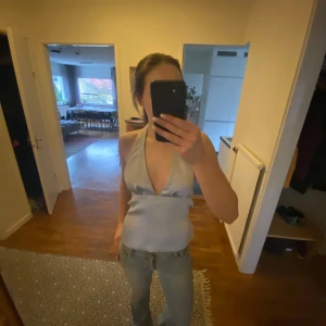 Snygg blå topp från Zara - Snygg topp från Zara i ett blått glansigt material. Perfekt till utekväll eller fest. Aldrig använd.