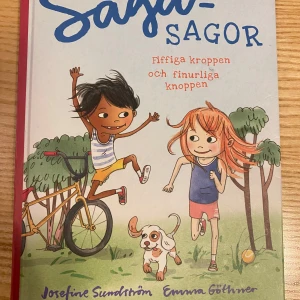 Saga-sagor: Fiffiga kroppen och finurliga knoppen - En charmig barnbok där Saga och Samir bygger en hinderbana för hunden Lars-Laban. Boken kombinerar berättelser med lätt fakta om kroppen och knoppen, och uppmuntrar barn att röra på sig. Perfekt för nyfikna barn som vill lära sig mer om hur kroppen fungerar på ett roligt sätt.