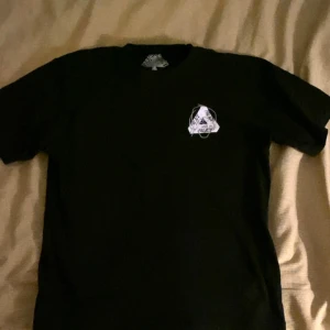 Svart t-shirt från Palace - Snygg svart t-shirt från Palace med deras ikoniska triangel-logga i vitt på både fram- och bak sidan. 9/10 skick