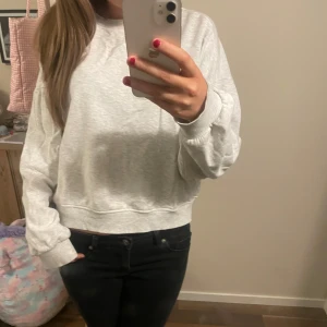 Grå sweatshirt - Säljer en bekväm grå sweatshirt med långa ärmar och ribbade muddar. Perfekt för en avslappnad stil. Passar bra till jeans eller leggings🩷