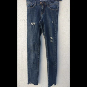 Jeans från Denim - Jeansen är skinny och designen har hål på låren ner till smalbenen. Säljer de eftersom de inte längre passar. 